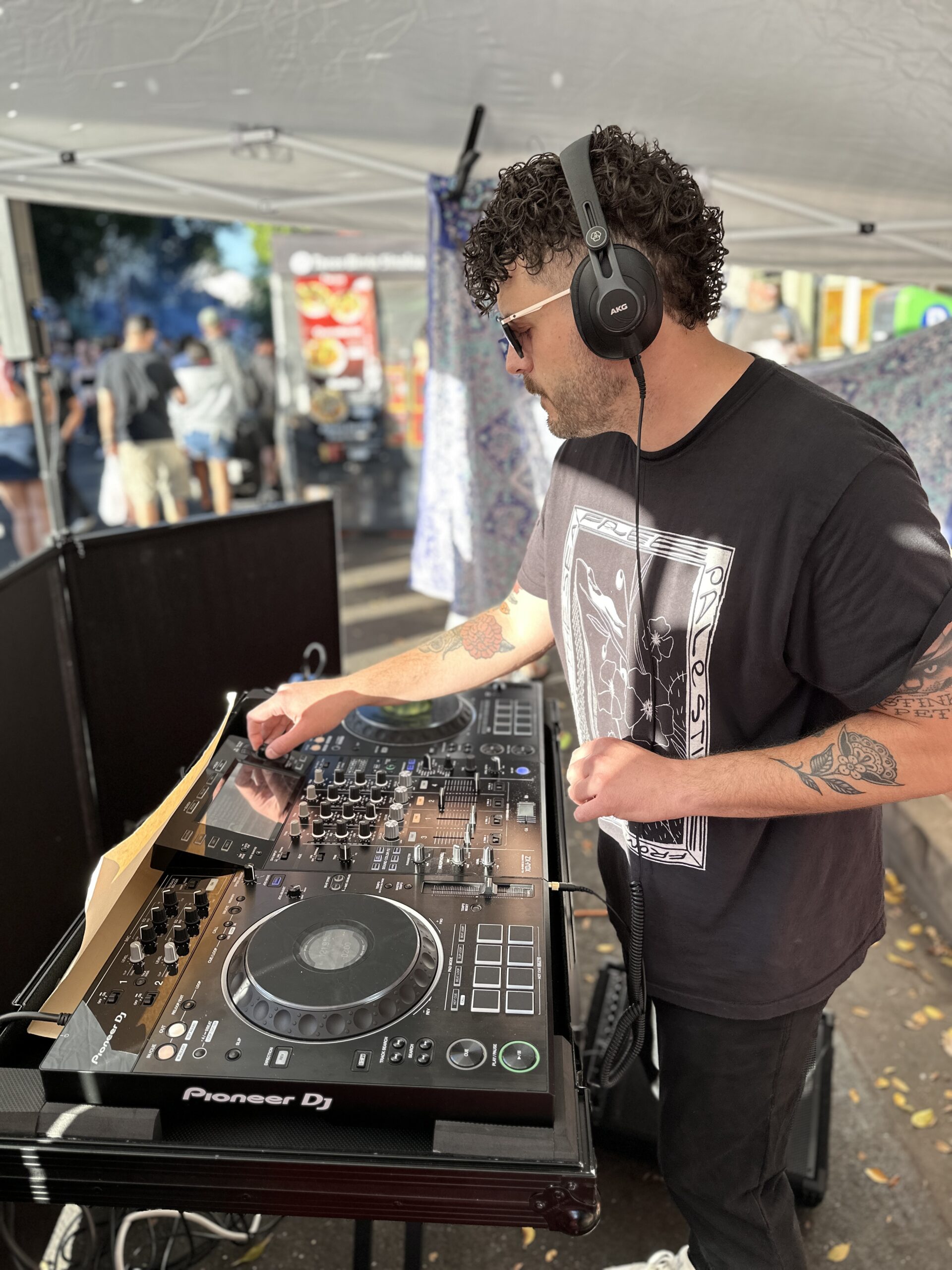 Photo of just ge.rge behind the decks at the San Luis Obispo Farmer's Market